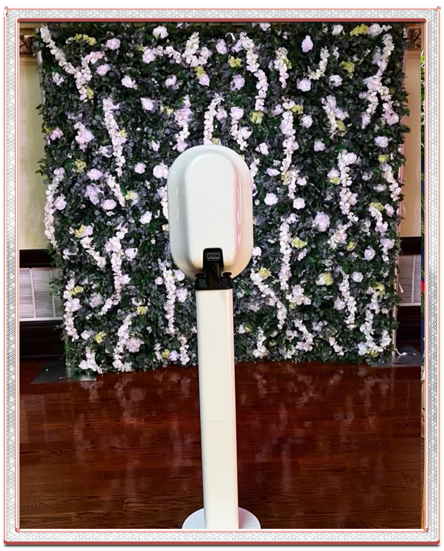 flower wall rental with green foliage and white blooms with a photo booth rental